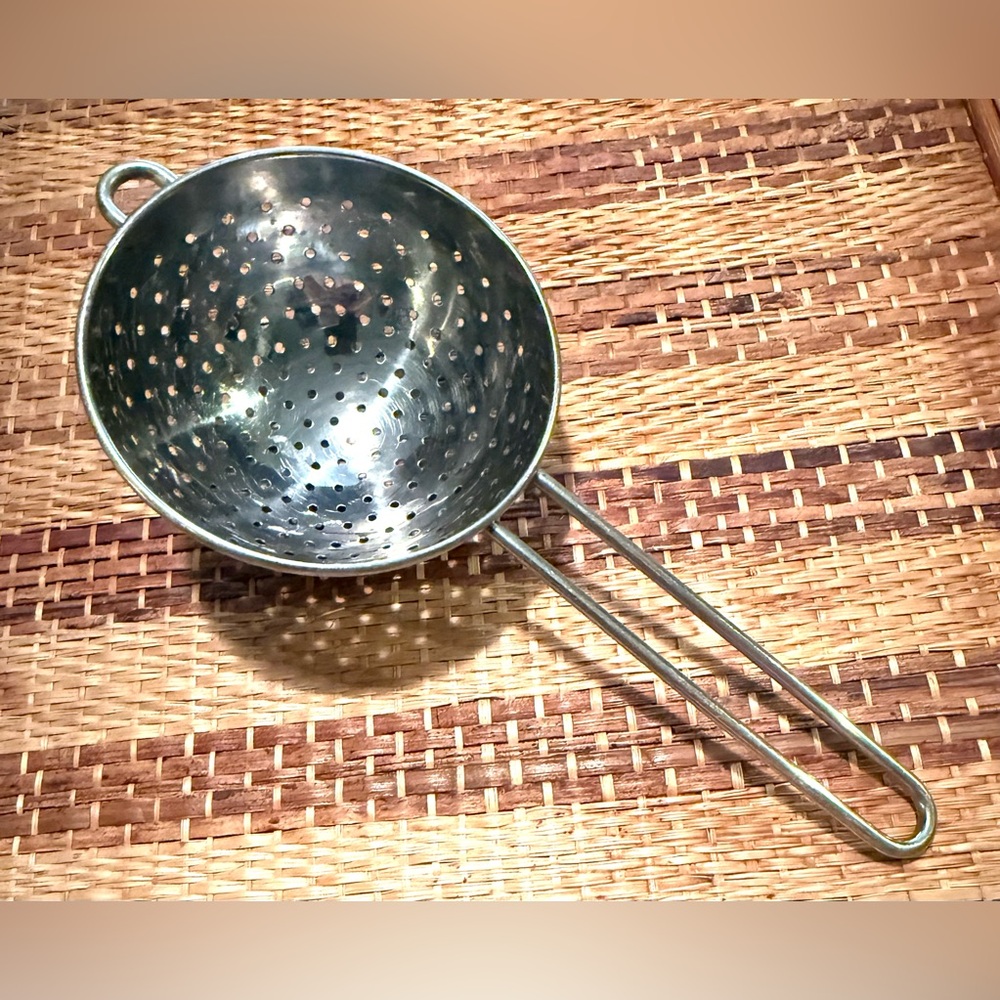 A stainless steel colander or tea strainer with a long handle.Wont rust,corode